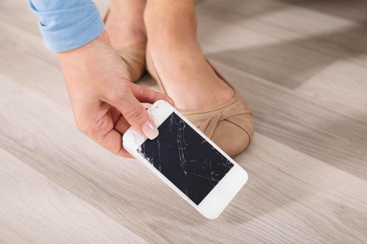  phone;mobile;broken;cracked;repair;screen;smartphone;drop;insurance;gadget;woman;picking;smart;foot;damage;floor;crash;hold;smashed;digital;crack;old;hand;cell;glass;technician;people;tech;person;shattered;holding;damaged;device;hardwood;electronic;technology;footwear;human;equipment;modern;single;communication;display;adult;wireless;object;one;woodgrain;indoors;caucasian 