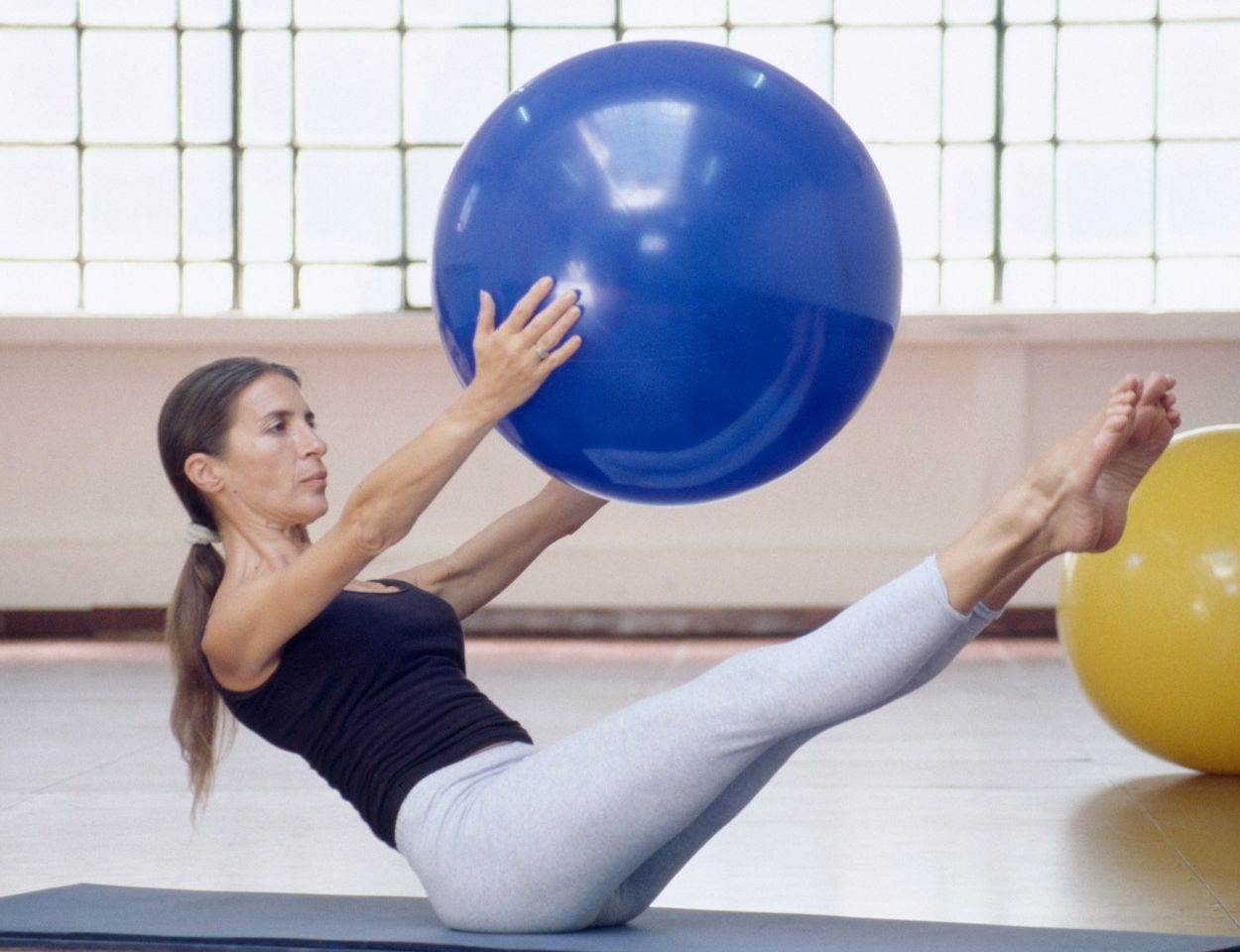  woman;female;exercises;exercise;pilates;exercising;system;method;technique;fitness;fit;healthy;health;balance;balancing;arm;stomach;leg;muscle;muscles;posture;pastime;hobby;sport;sporting;leisure;people;activity;activities;mat;floor;gym;gymnasium;swiss;ball 